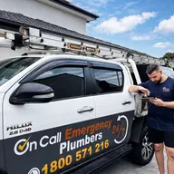 Plumber beside a fully equipped service van, Carrum Downs